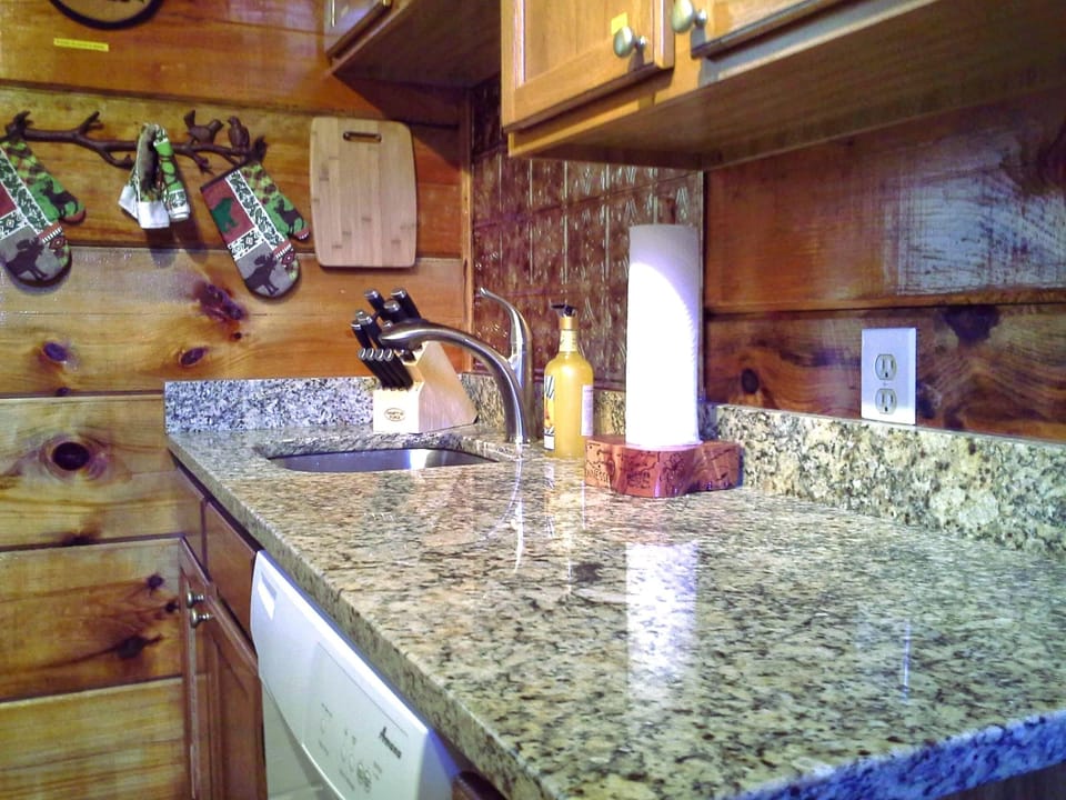 Solid granite counter tops, deep stainless sink with hand sprayer, dish soap and dishwasher pods provided