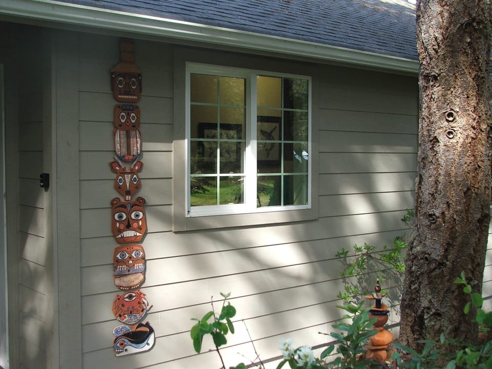 Front door, located on the side of the house, and some locally inspired artwork