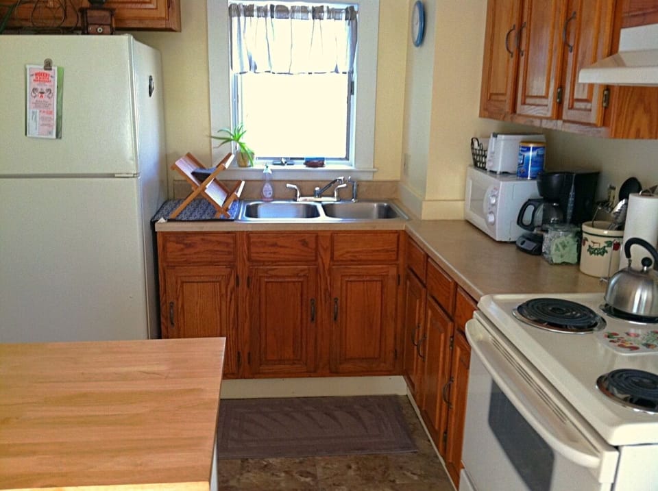 The kitchen has a full sized fridge, microwave and stove/oven range.