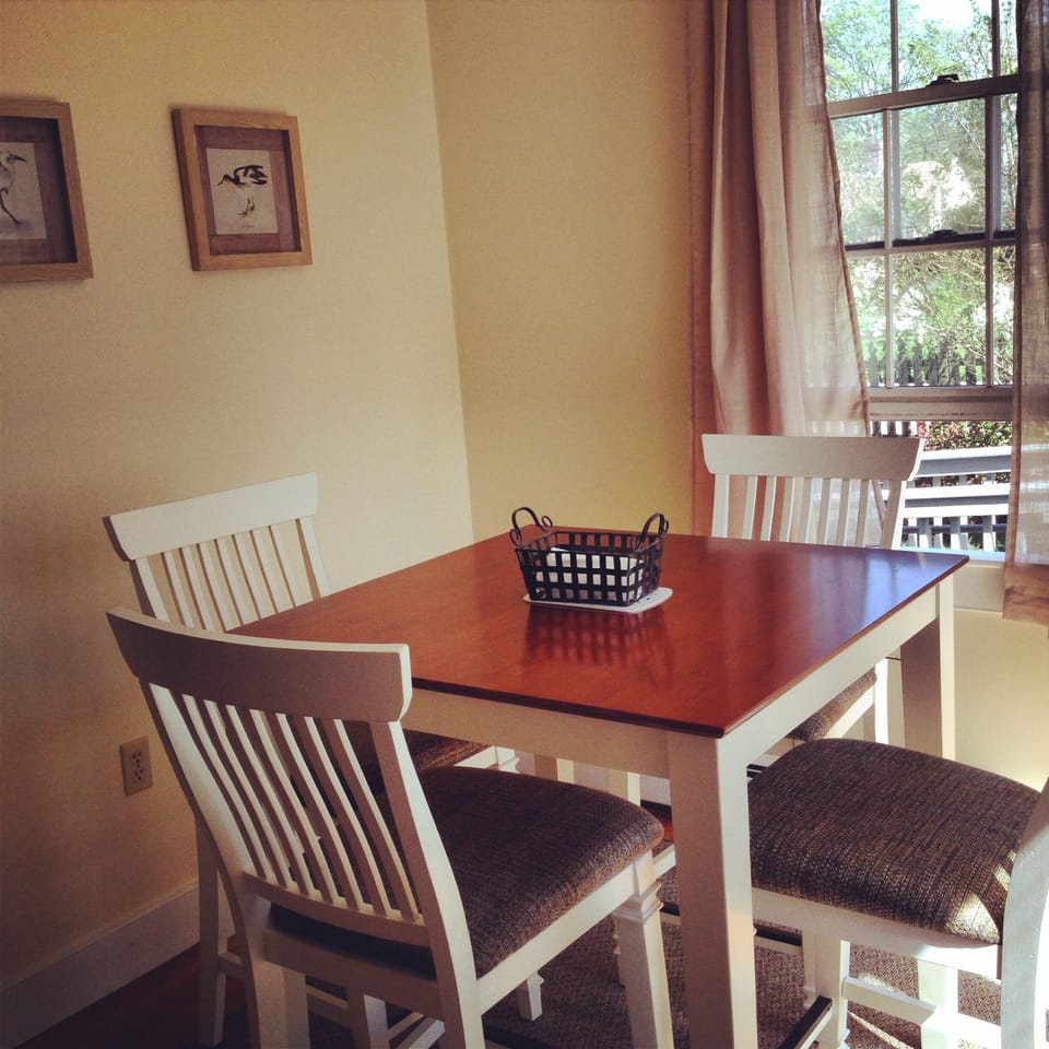 Comfortable dining area with sliding glass door leading to the back deck.