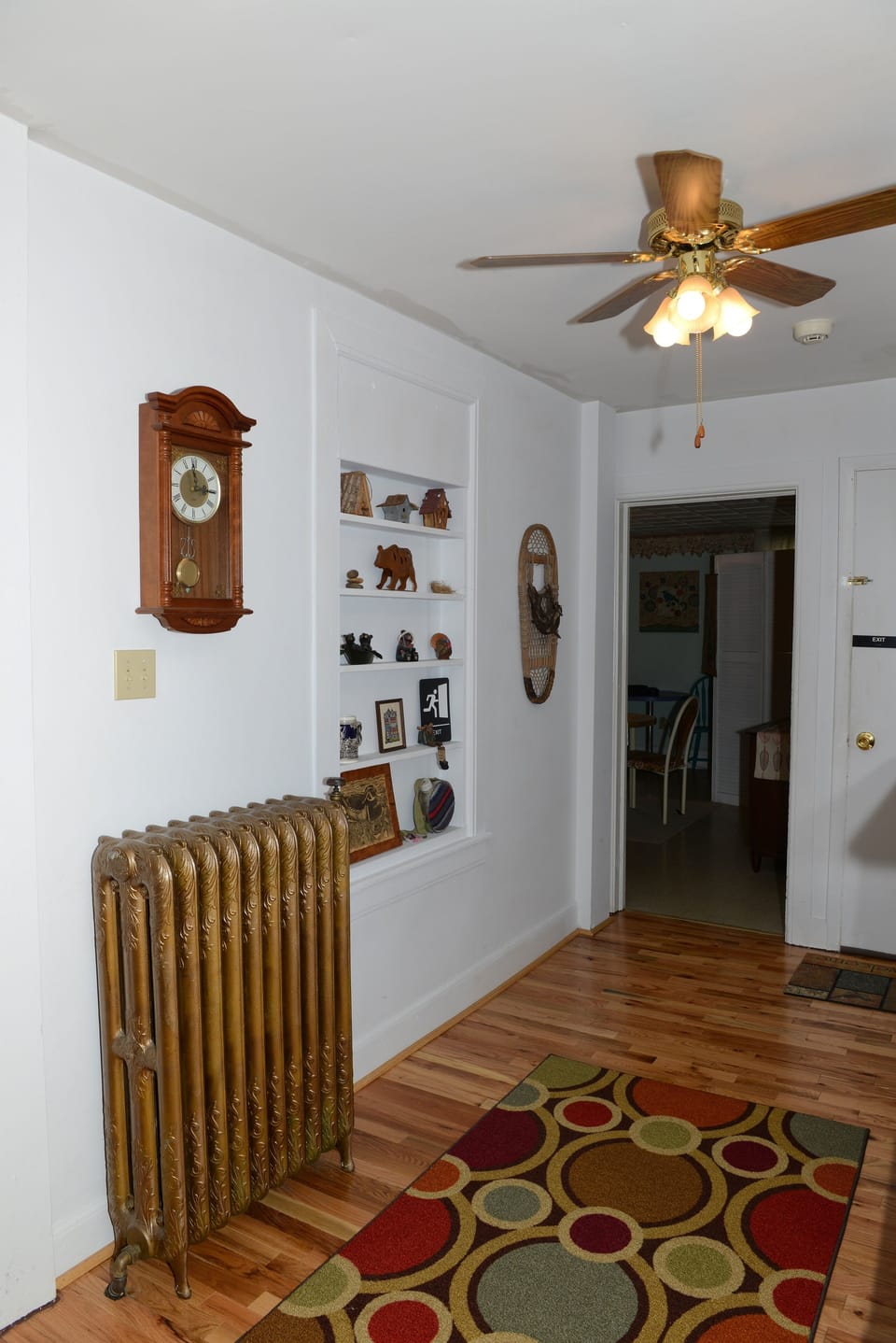The entrance with original, antique gold cast iron radiator 