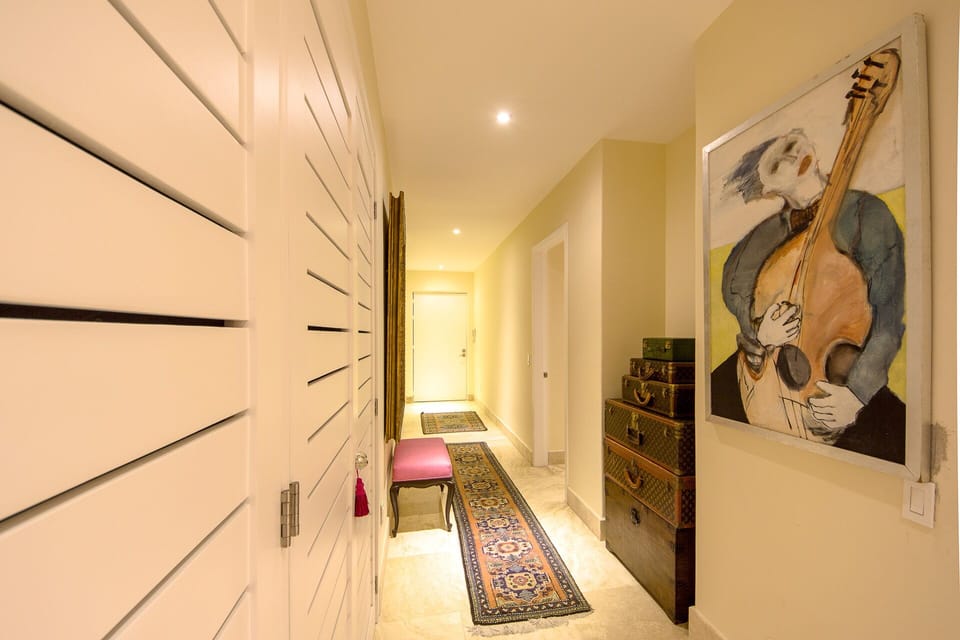 Grand hallway entrance filled with beautiful artwork and Vintage Vitton.