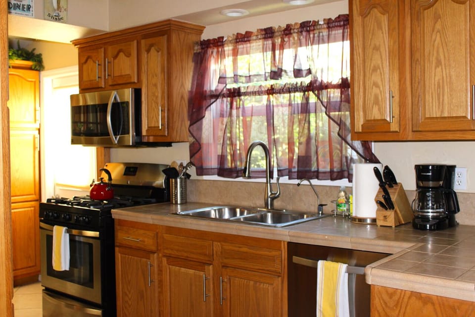 Fully stocked kitchen with stainless steel appliances 