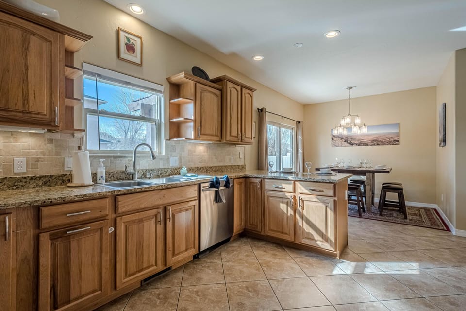 A wide-open kitchen with wood tones that ground it and light that lifts it.