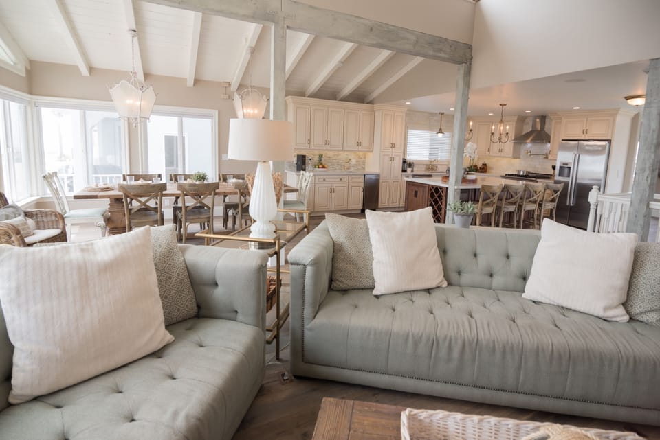 Two large cozy sofas & two chairs frame the fire place and flat screen tv.