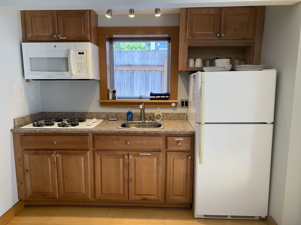 Kitchen comes with dishes, glasses, cooking pots, microwave, coffee makers, etc