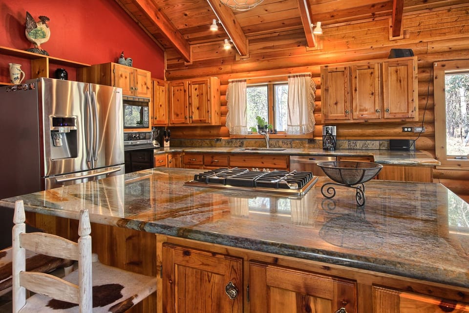 Gourmet kitchen fully equipped with cookware and serving ware.