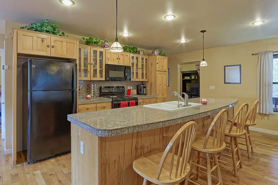 Fully stocked kitchen with newer appliances and granite countertops.