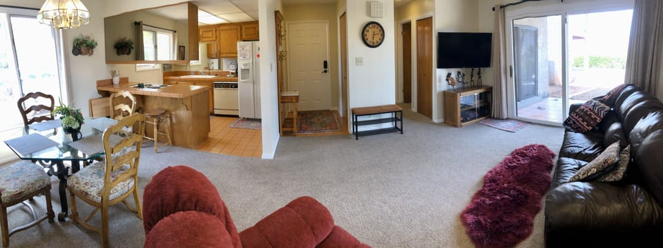 Open concept living and kitchen areas with big screen smart TV.