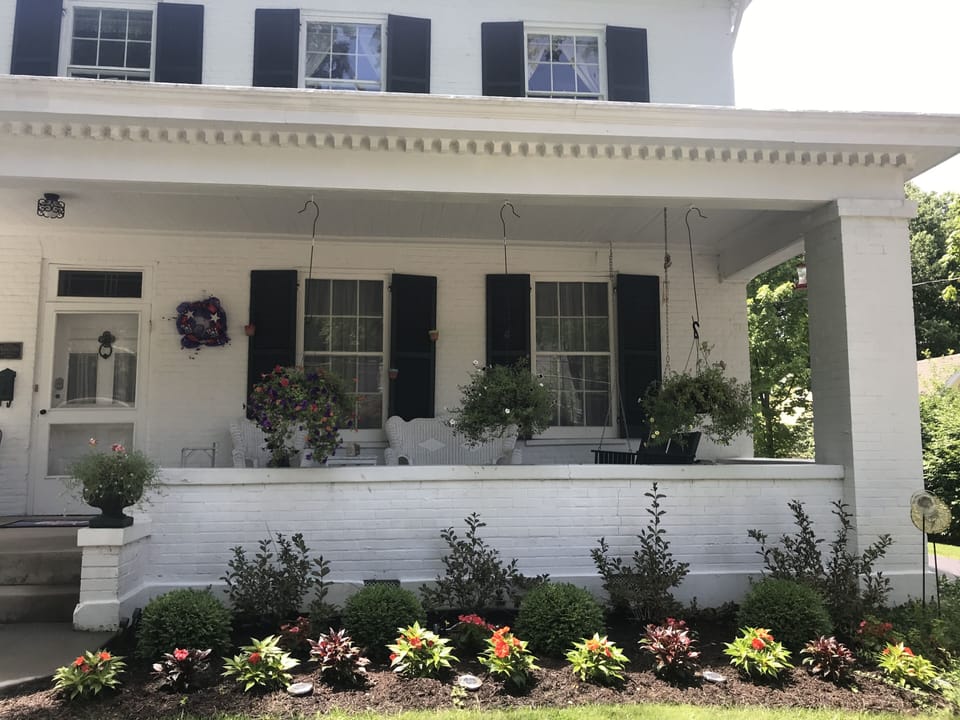 Summer is here!  Flowers are blooming!  Come and sit on the front porch.