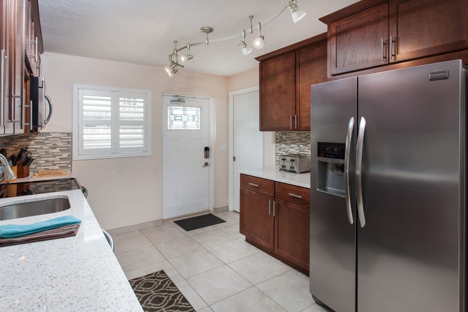 Kitchen with Stainless Steel Appliances and Crushed Shell & Concrete Countertop