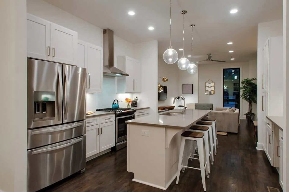 Cook, gather, and unwind in this airy kitchen featuring a roomy island and spacious counters.