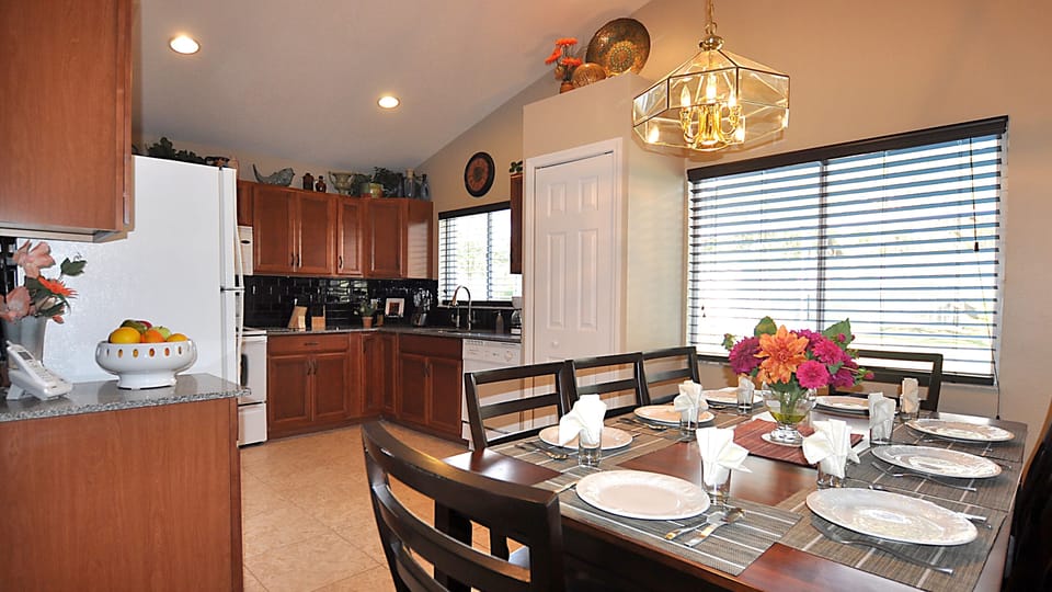 The fully-equipped Kitchen with seating for eight overlooks the pool & lanai.