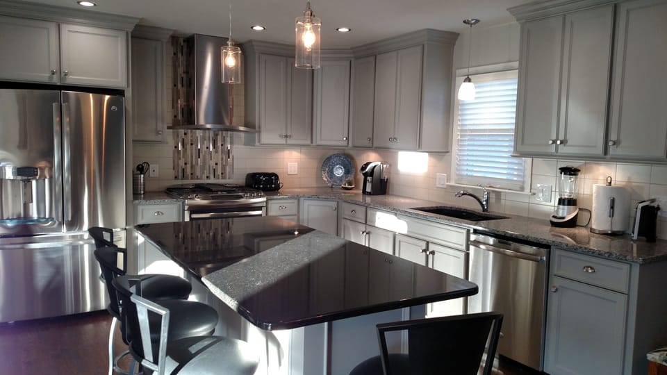 Large open kitchen with four kitchen counter stools