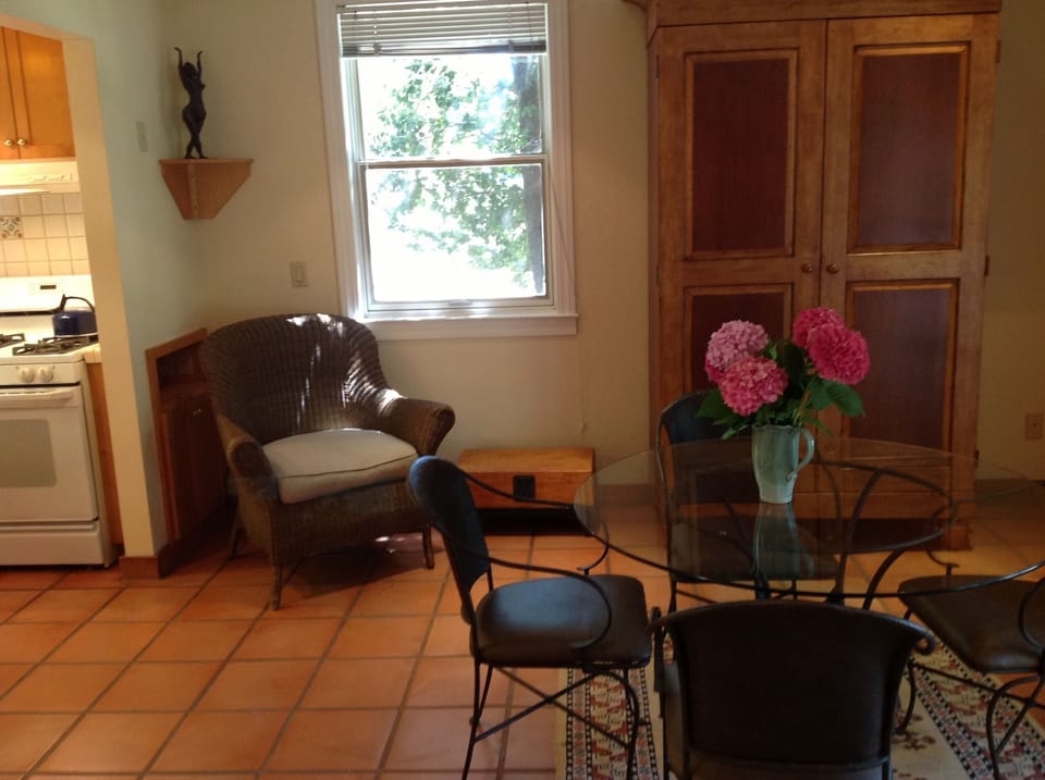 Dining area with antique furniture and oriental rug.