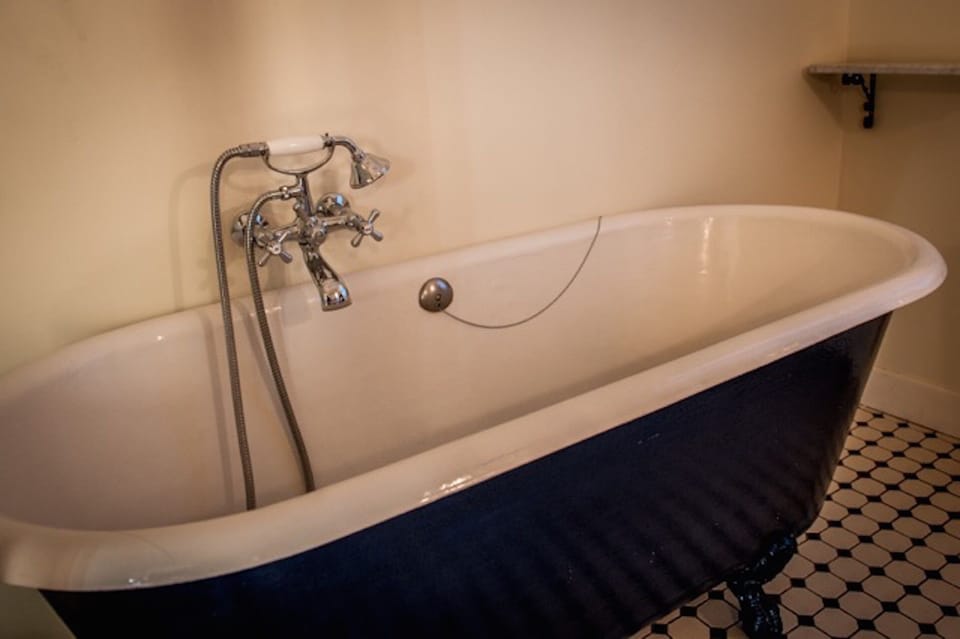 Antique claw-foot tub in second floor bathroom (in addition to a shower).