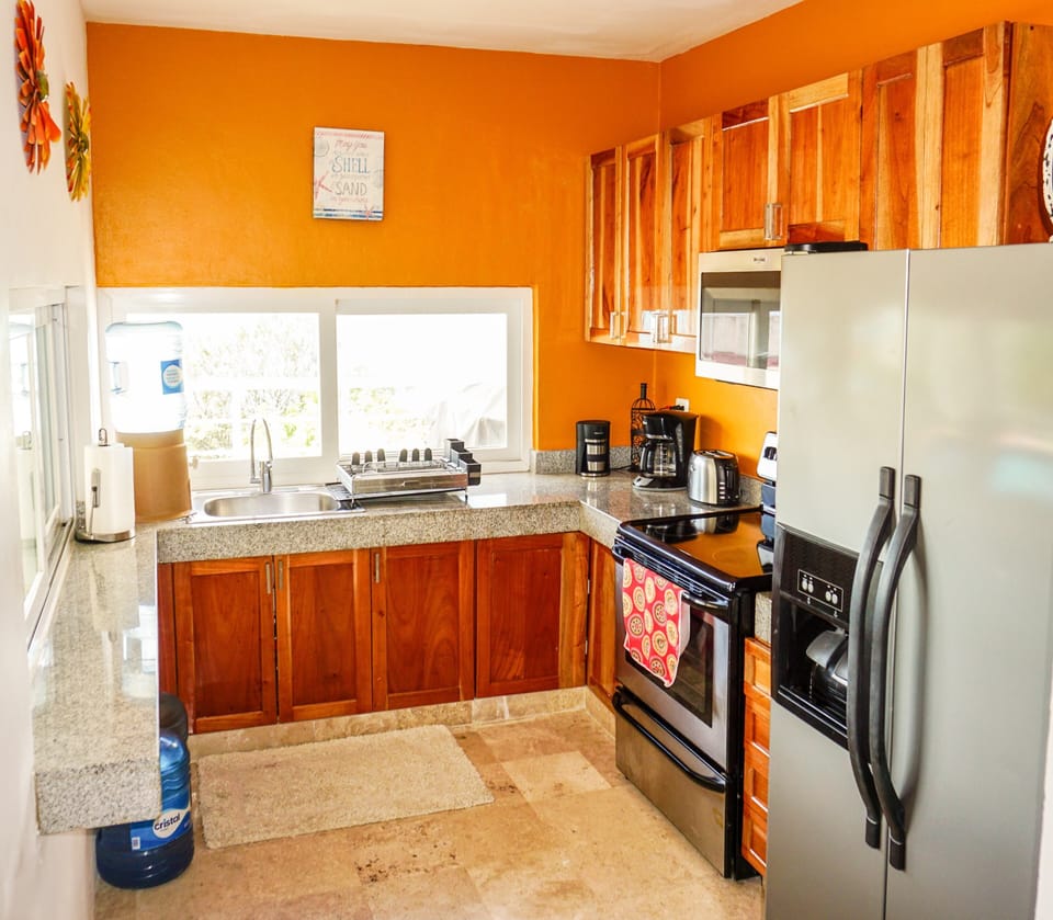 The kitchen area, serve snacks or margs through the sliding windows to the patio
