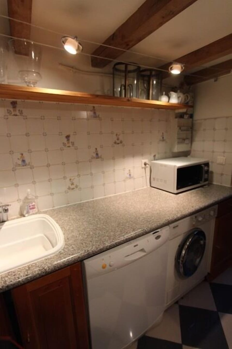 Kitchen showing dishwasher, washer/dryer and microwave