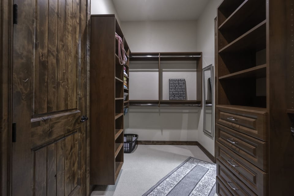 master closet with play pen, drawers and plenty hangers for hanging clothes...