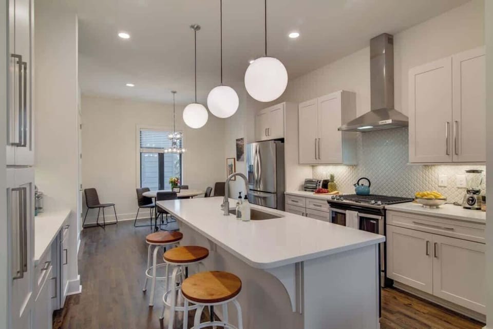 Craft delicious meals with ease in our fully-equipped kitchen, featuring a welcoming island bar perfect for both meal preparation and casual dining experiences.