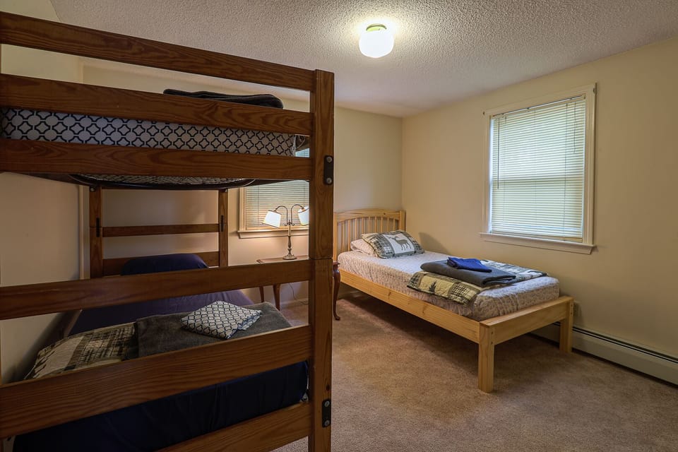 Guest house bedroom 2 one set of bunk beds and a twin bed