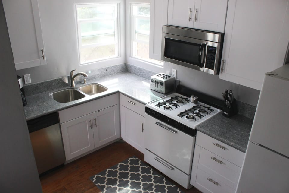 Modern clean and well equipped kitchen with stainless appliances