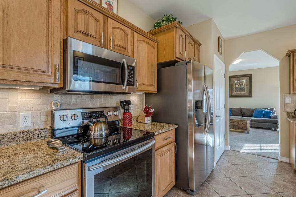 A light-filled kitchen built for everyday cooking, with granite countertops and polished stainless appliances