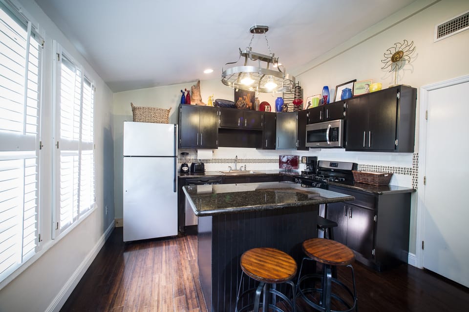 The kitchen is downstairs, with seating around the island