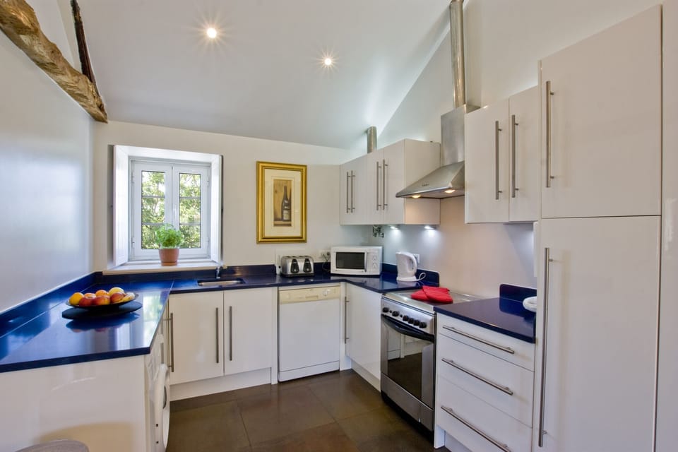 Fitted kitchen including washing machine, dishwasher and microwave oven.