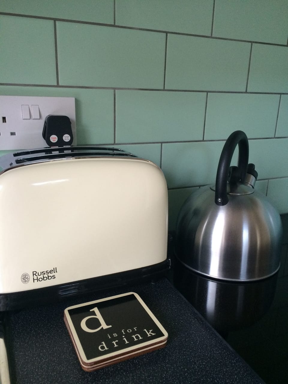 The kitchen is fully equipped with a full size cooker and fridge