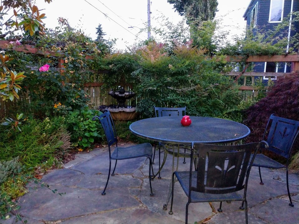 A welcoming trellis fenced  courtyard or flagstone patio