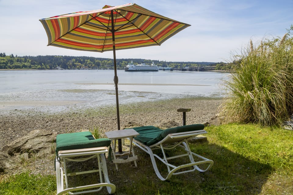 Beach recliners with Bainbridge Island ferry dock in distance
