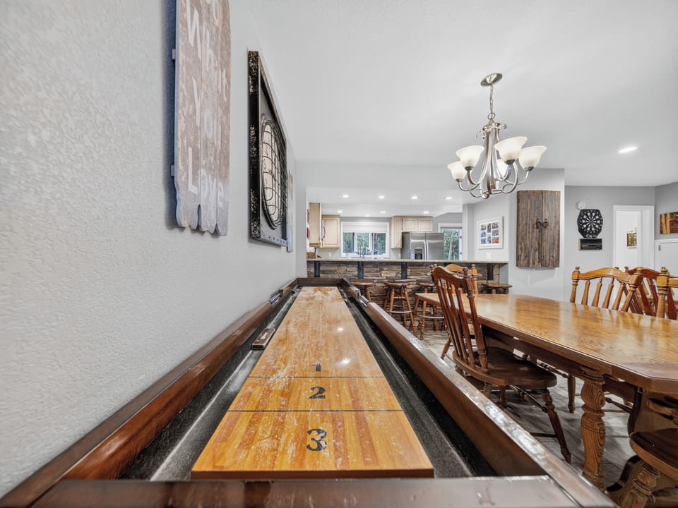 Challenge your group to a friendly shuffleboard match before gathering around the dining table. This open-concept game and dining space makes entertaining easy and memorable.