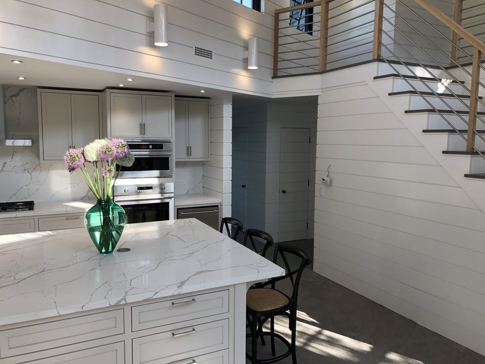 Kitchen staircase to upper level with 3 additional bedrooms and two baths.