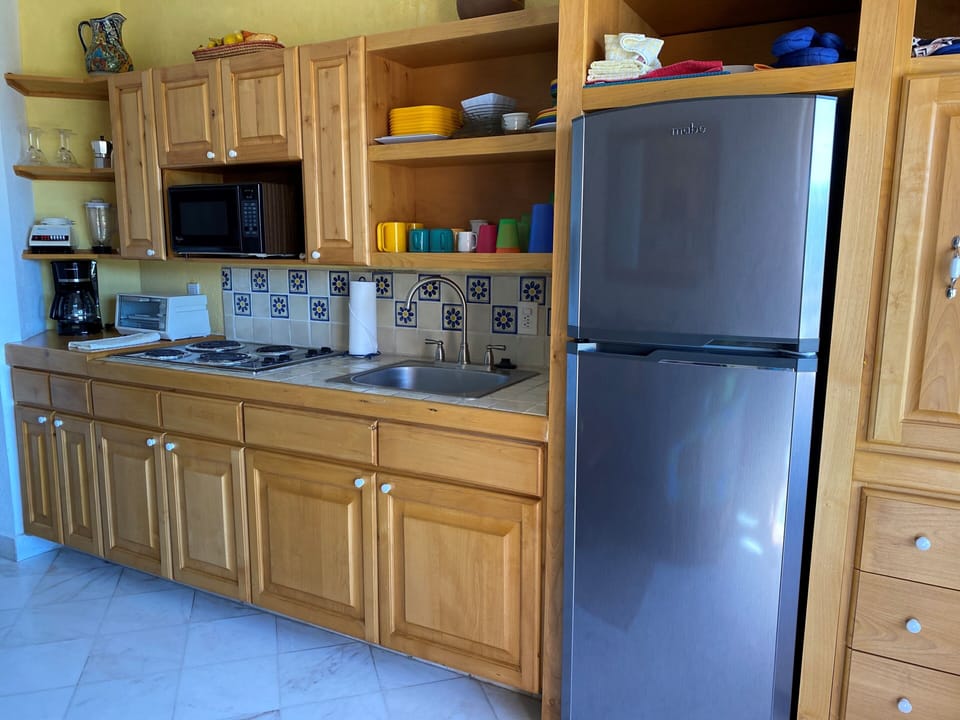 Fully equipped kitchen w/ dishes, utensils, pots & pans, oil, spice, and more! 