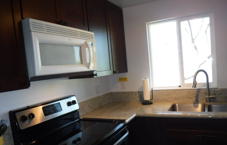 A new kitchen with beautiful cabinets, granite counters and oceanfront views.