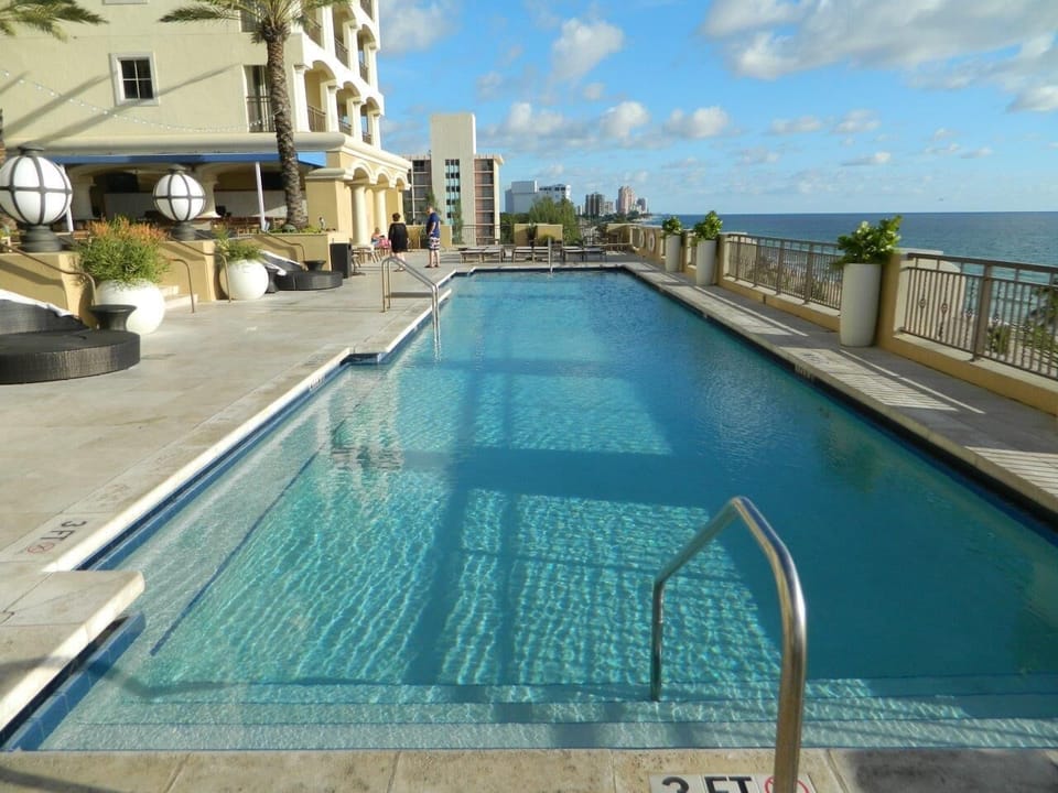Swimming pool next to bar and terrace