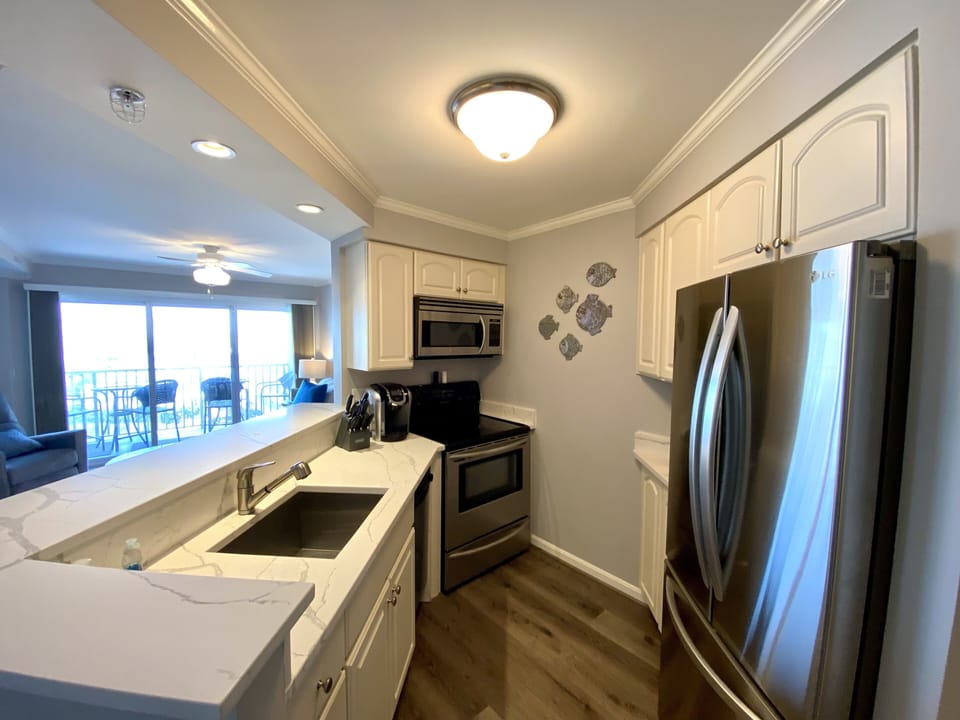 Kitchen with side by side Refrigerator Lower Freezer with Ice Maker