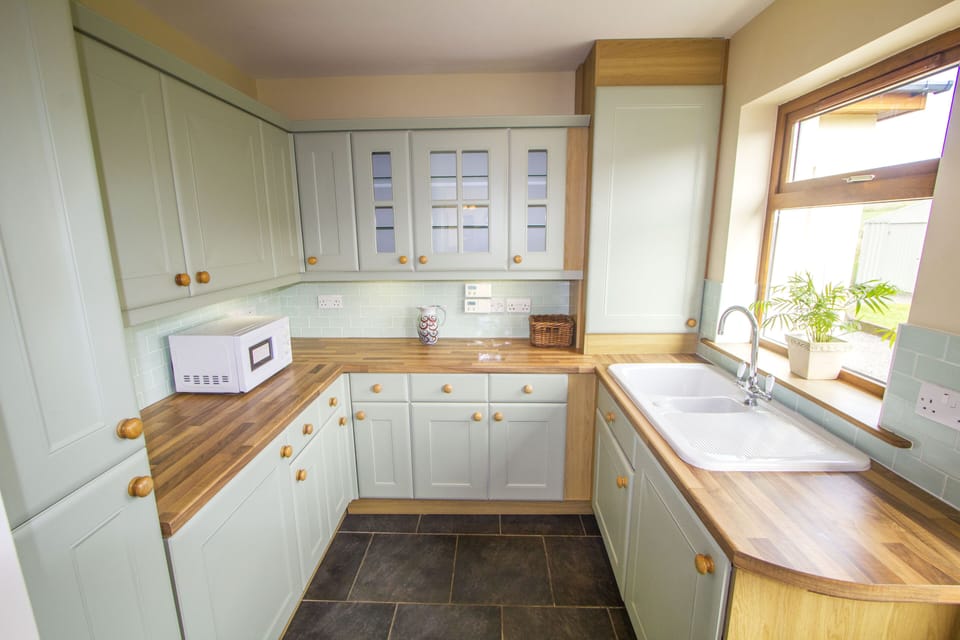 Spacious utility room adjoining the kitchen with 2nd fridge-freezer, microwave, washer and drier