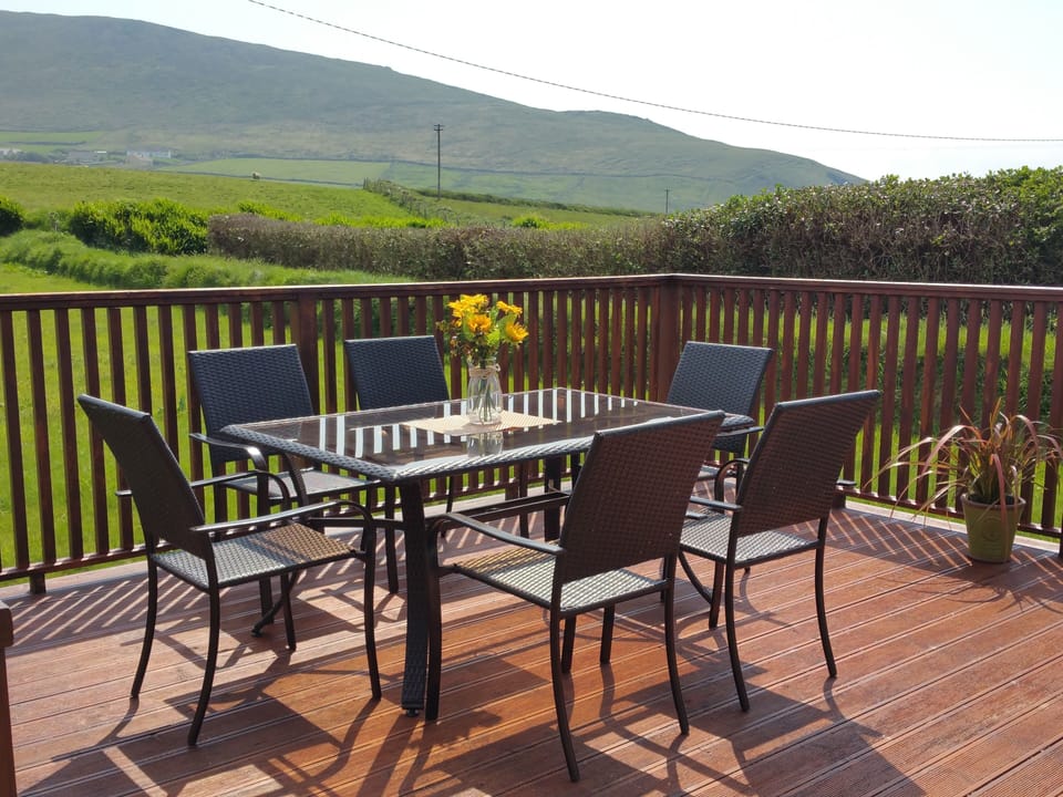 Deck off kitchen/Dining room. Overlooks big back lawn, fields, mountain & ocean