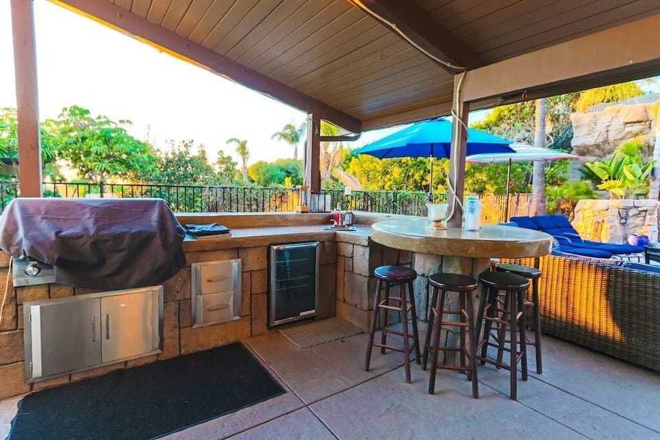 Out door kitchen with mini fridge and propane free grill.