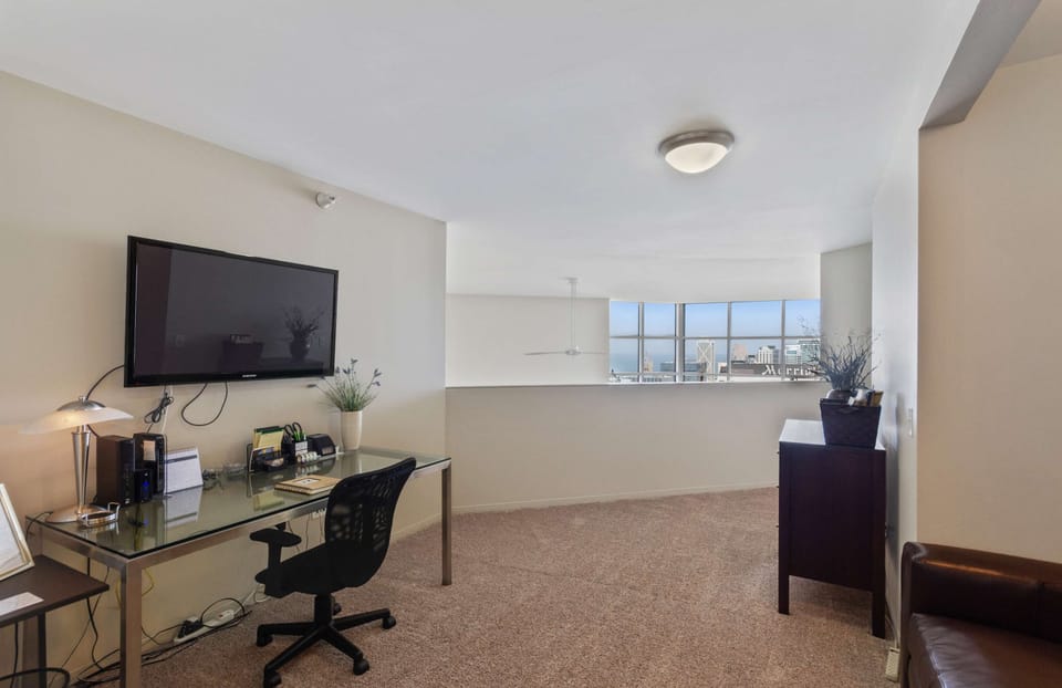 Upstairs loft with full sized sleeper sofa, TV and workstation.