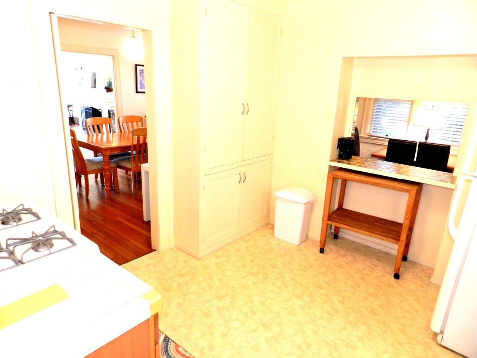 View of dining room, pass through breakfast nook, cabinet full of dishes