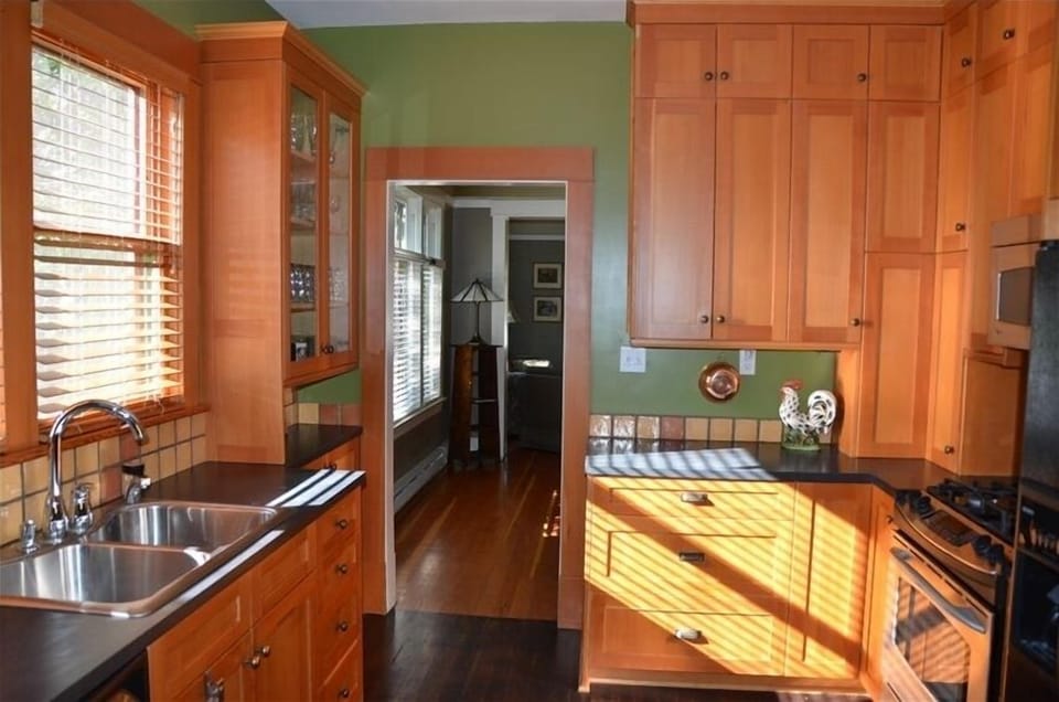 Large kitchen with gas stove, side by side fridge and dishwasher.