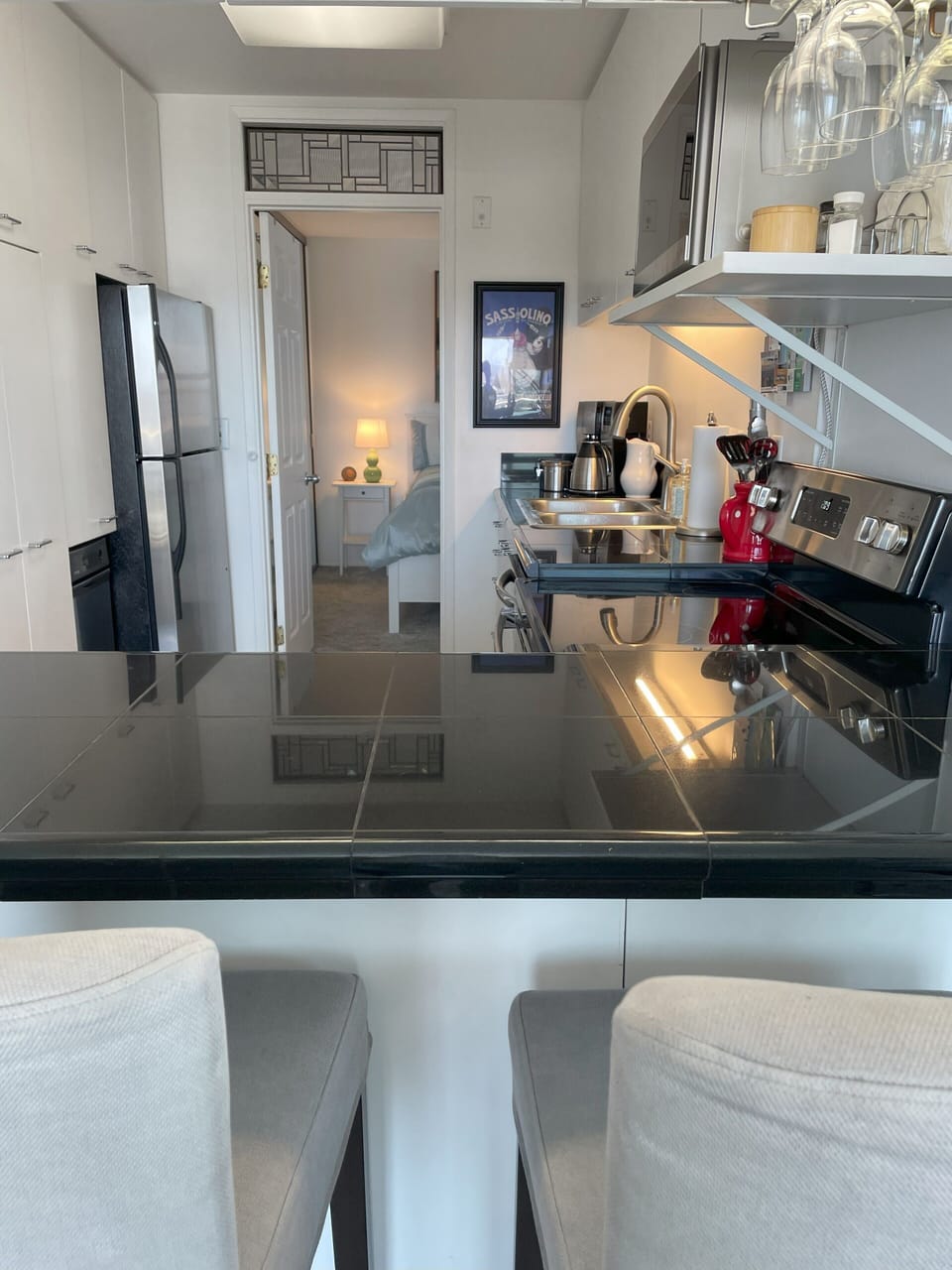 Kitchen and door leading to the bedroom.  