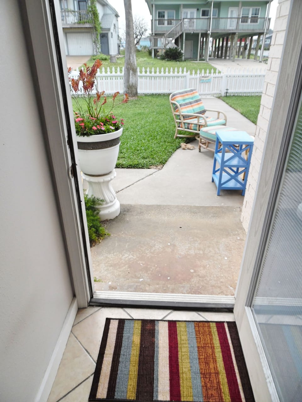 Hallway opens to fenced front yard and outdoor seating