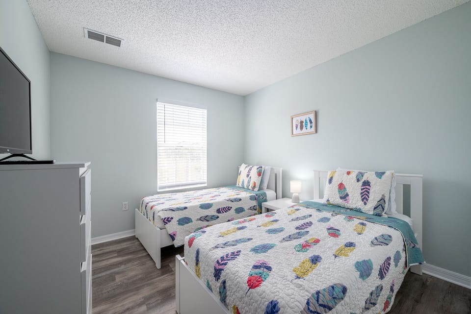 Twin bedroom with streaming on TV