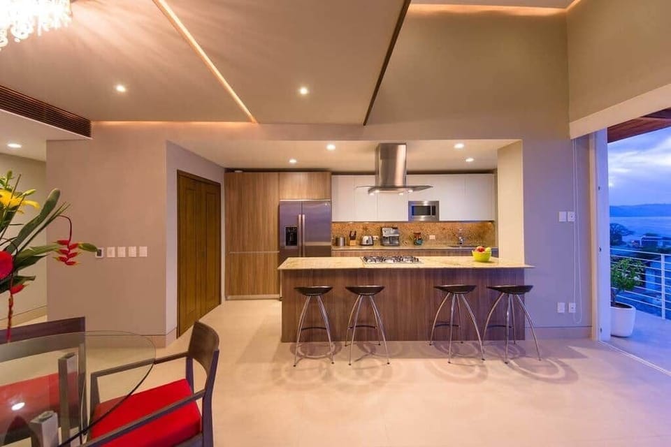 Open living dining and kitchen with a loft above.