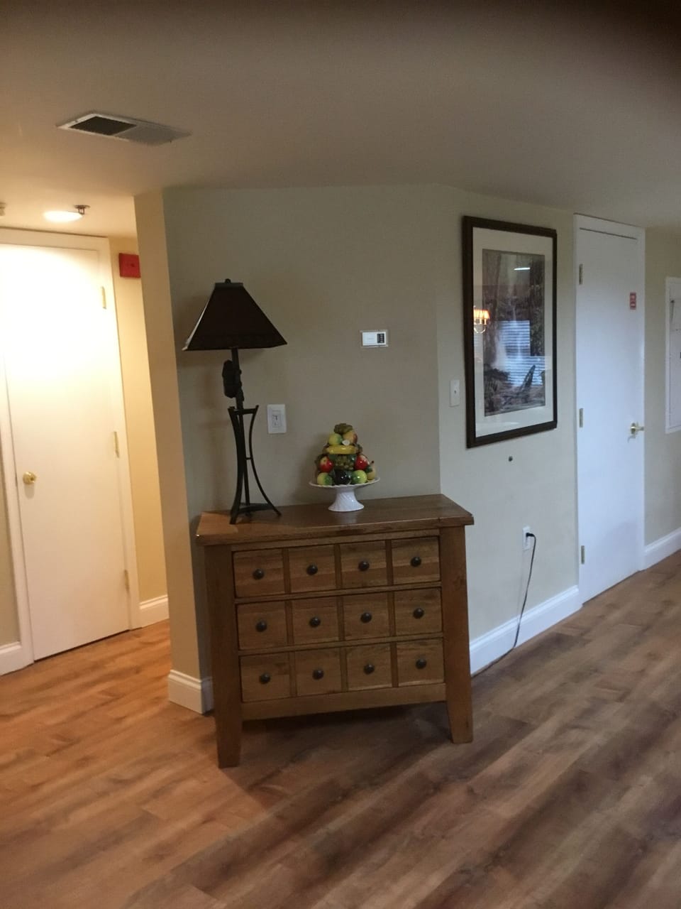 Left of this cabinet, is hallway to both bedrooms, one on each end.