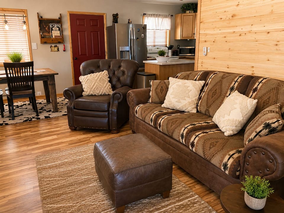Sink into plush seating and feel the warmth of natural wood surrounding you in this open-concept living space, where rustic charm meets modern comfort for your mountain retreat.